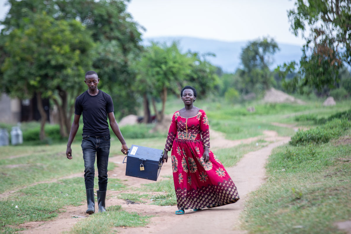 A man and a woman carring a large box between them.