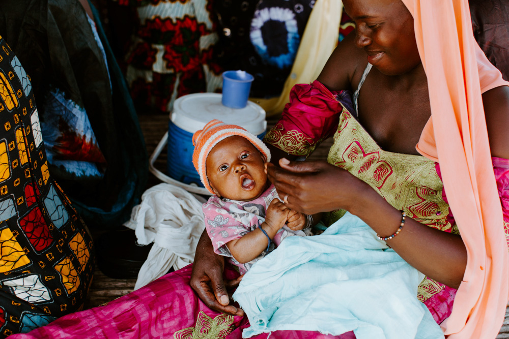 A woman feeding her baby. 