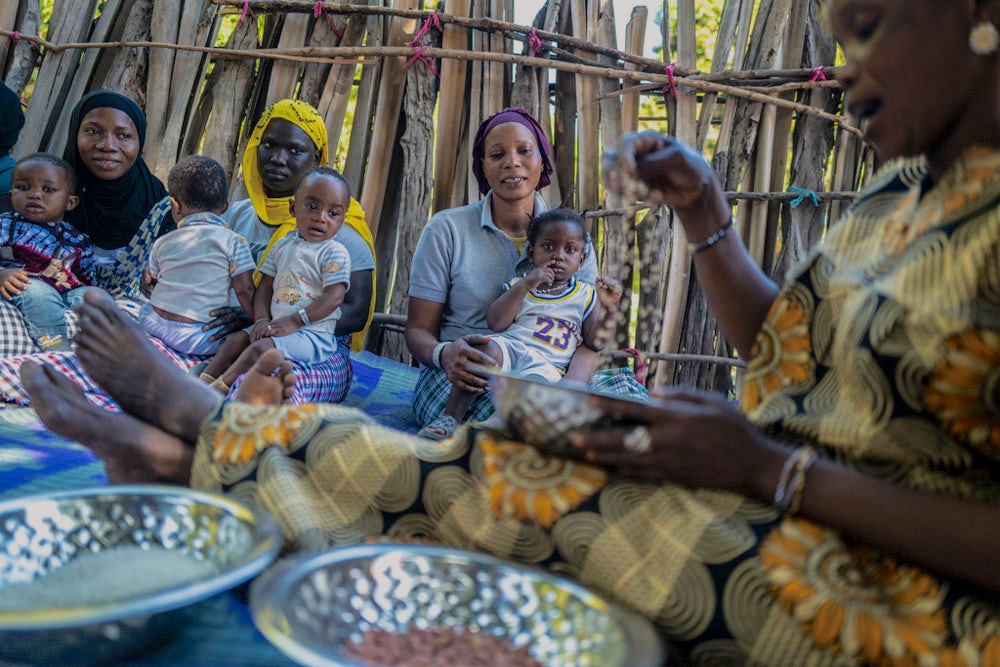 A Heifer-trained community facilitator teaches mothers in her Senegalese village how to make nutrient-dense porridge.