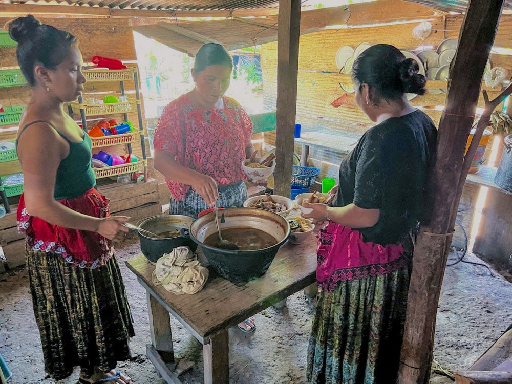Two women from Guatemala prepare lunch for their relatives.