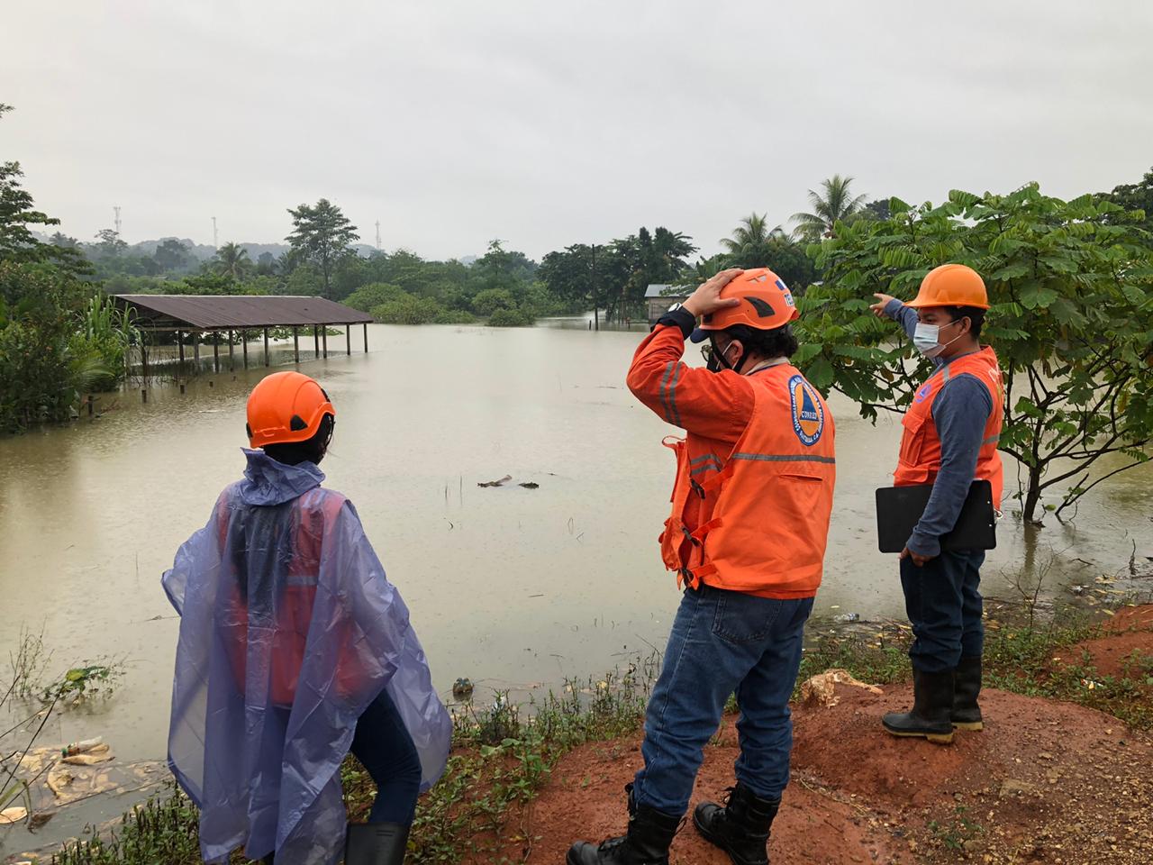 Emergency workers survey flooding in Chisec, Guatemala. 